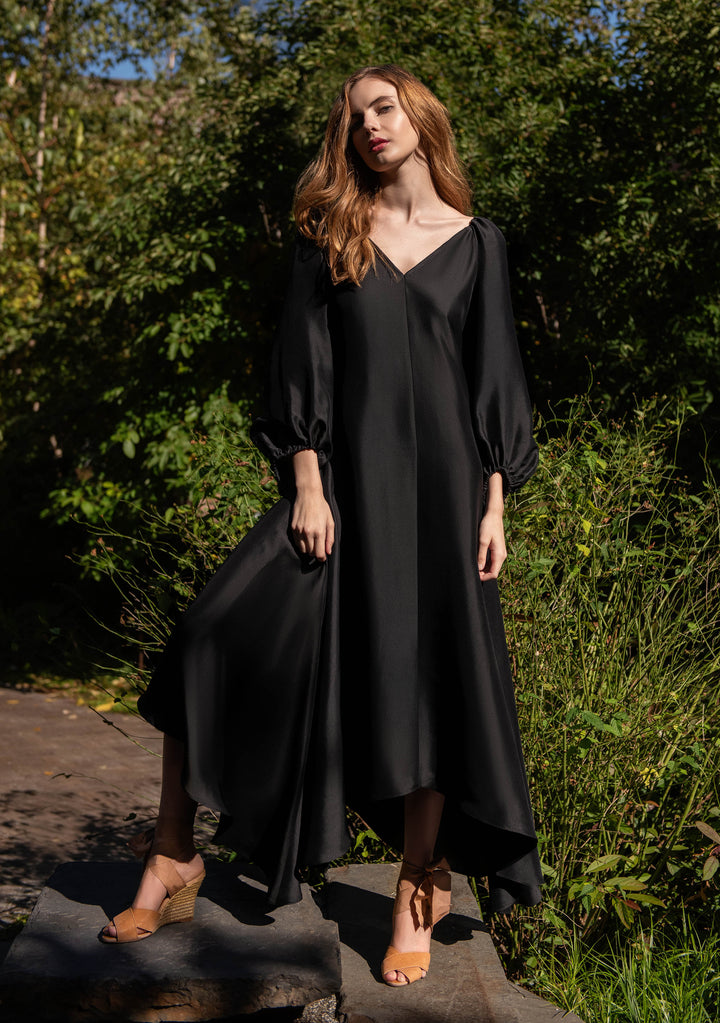 front view of woman wearing black puff sleeve silk dress front and back v neck